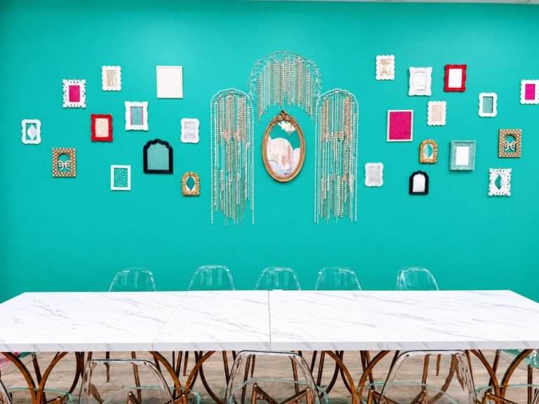 Teal mirror wall and activity table at Posh & Pearl Studio