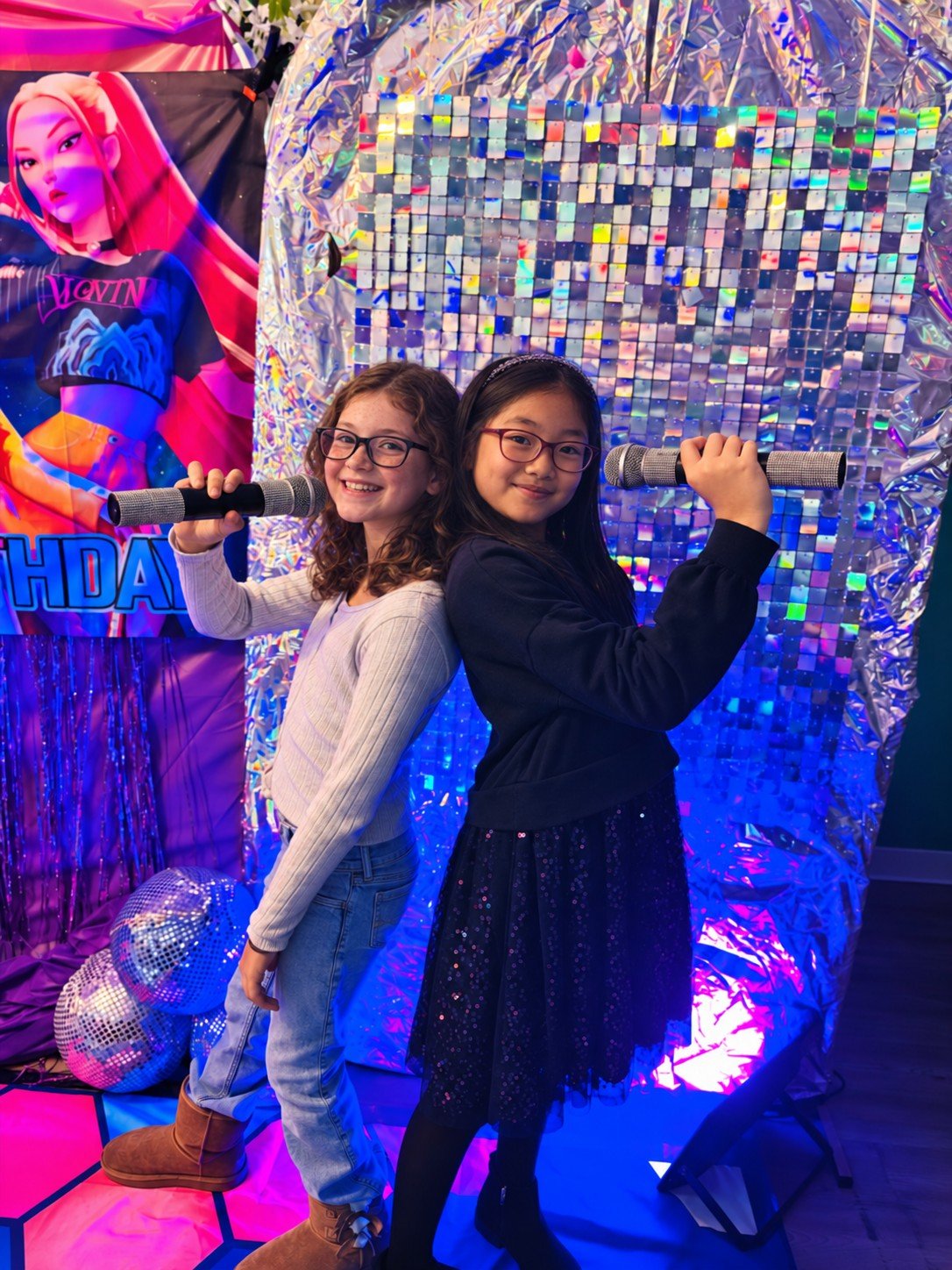 Girls holding microphones at a KPop Glow Party at Posh & Pearl Studio
