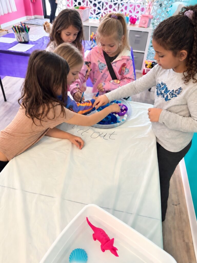 Children working together on a creative activity at Posh & Pearl Studio